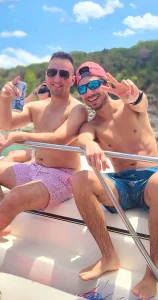 2 guys in a party boat on Lake Travis visiting Devil's Cove
