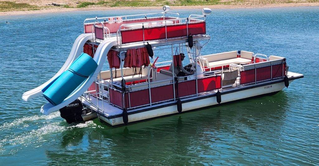 Islander Double Deck Party Boat Rental with slide, holds 19 passengers and is shown on lake travis