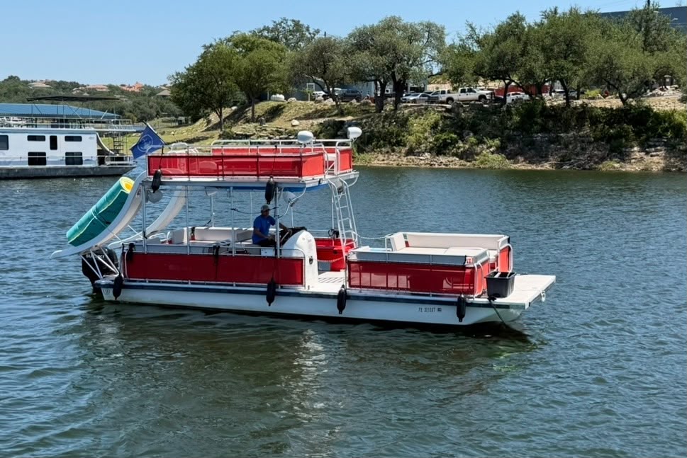 Islander Double Deck Party Boat Rental with slide, holds 19 passengers and is shown on lake travis